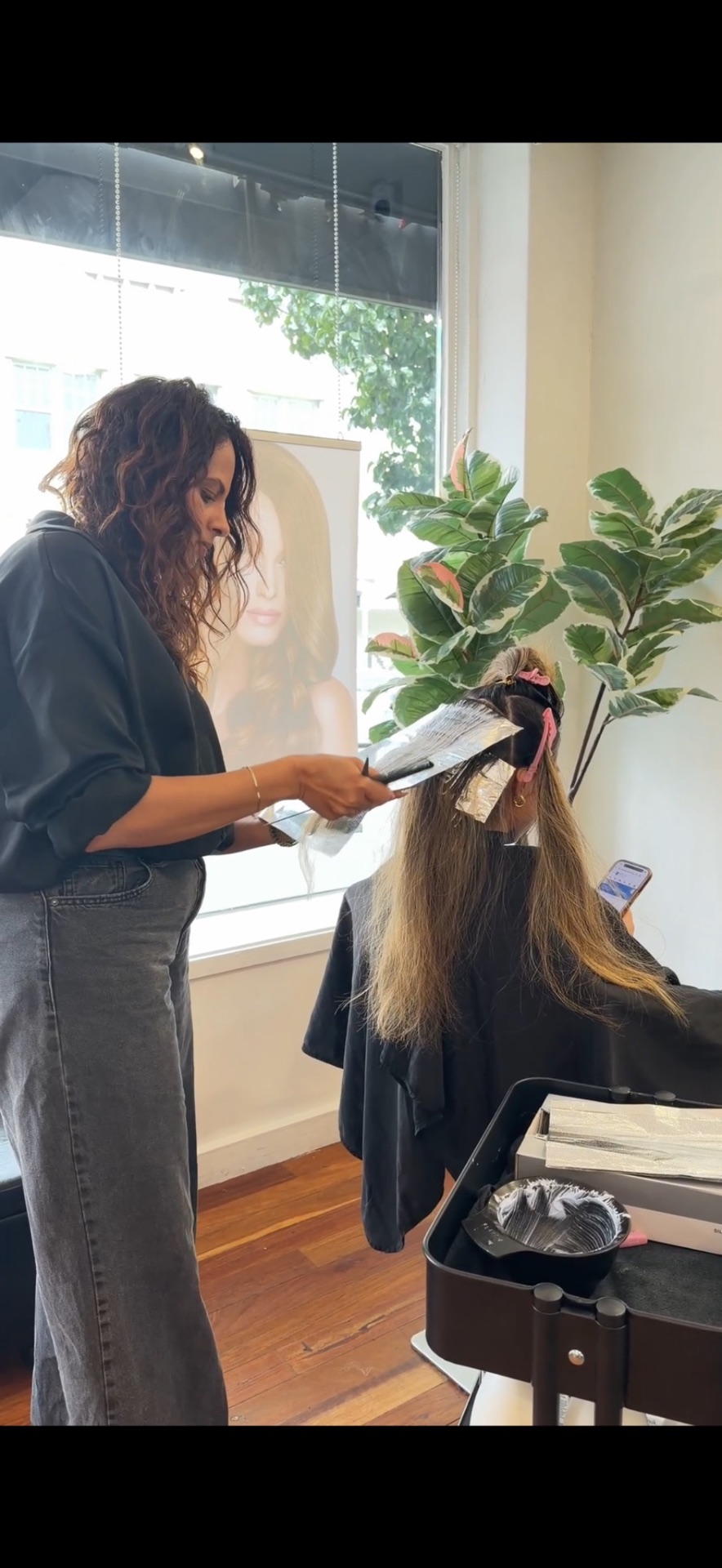 Glossy brunette balayage with soft waves styled by Shamalka